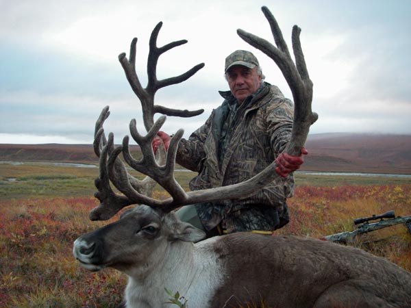 Hunter with Caribou, Arctic North Guides.